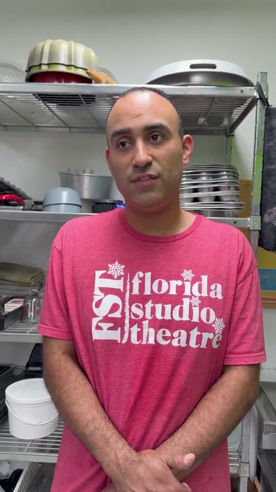 Adam speaking in a kitchen
